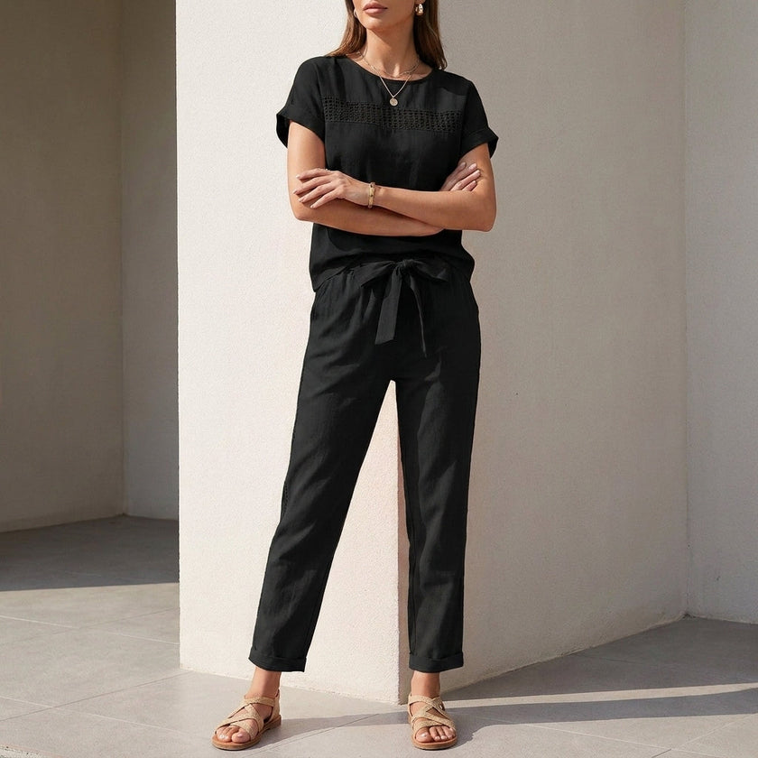Black FJØRNA women's two-piece co-ord set with mesh pockets, featuring a stylish top and matching pants for a modern look.