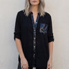 Black V-neck denim button-front summer blouse for women by FJØRNA, featuring a stylish and casual top with buttons down the front.