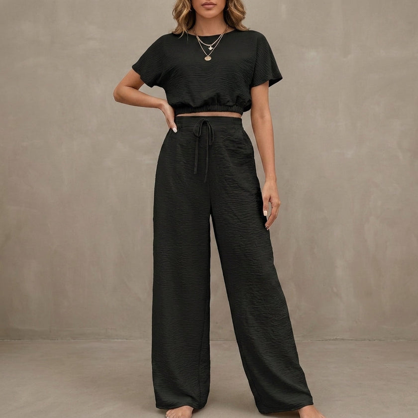 FJØRNA Coastal Breeze textured two-piece lounge set with wide-leg black pants and matching top, stylish and comfortable for relaxed wear.