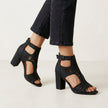 Black FJØRNA women's orthopedic heeled sandals with adjustable strap and buckle, showcasing stylish and supportive footwear.