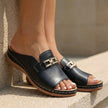 Black FJØRNA orthopedic slip-on sandals with buckle embellishment, featuring supportive design and comfortable open-toe style.