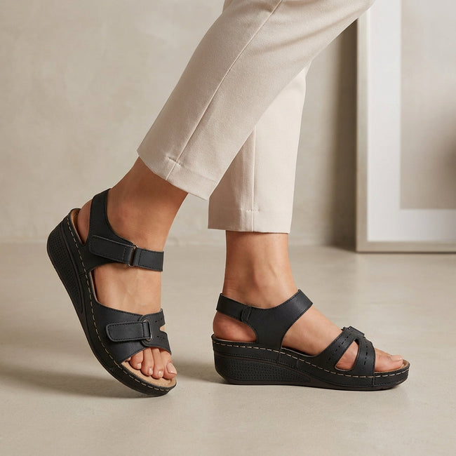 Black FJØRNA orthopedic open toe wedge heel sandals with comfort fit, featuring supportive design and stylish footbed.