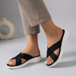 Black women's orthopedic sandals with adjustable criss-cross straps by FJØRNA, featuring supportive soles for comfort.