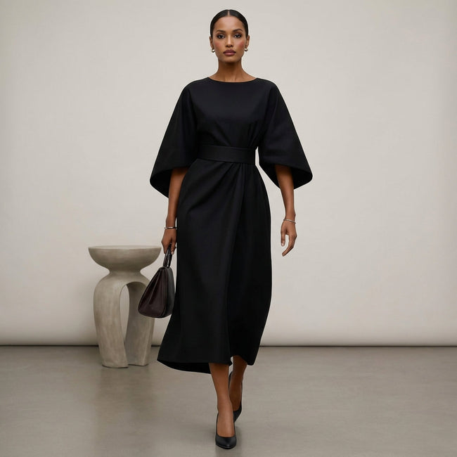 Black FJØRNA batwing sleeve wrap front belted maxi dress with slit, featuring flowing fabric and elegant design.