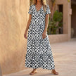 Black FJØRNA V-neck maxi dress with a ruffled hem, flowing fabric, and sleeveless design for elegant summer wear.