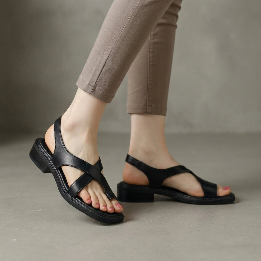 Black FJØRNA square toe block heel criss-cross women's sandals, featuring stylish open-toe design and comfortable chunky heel.