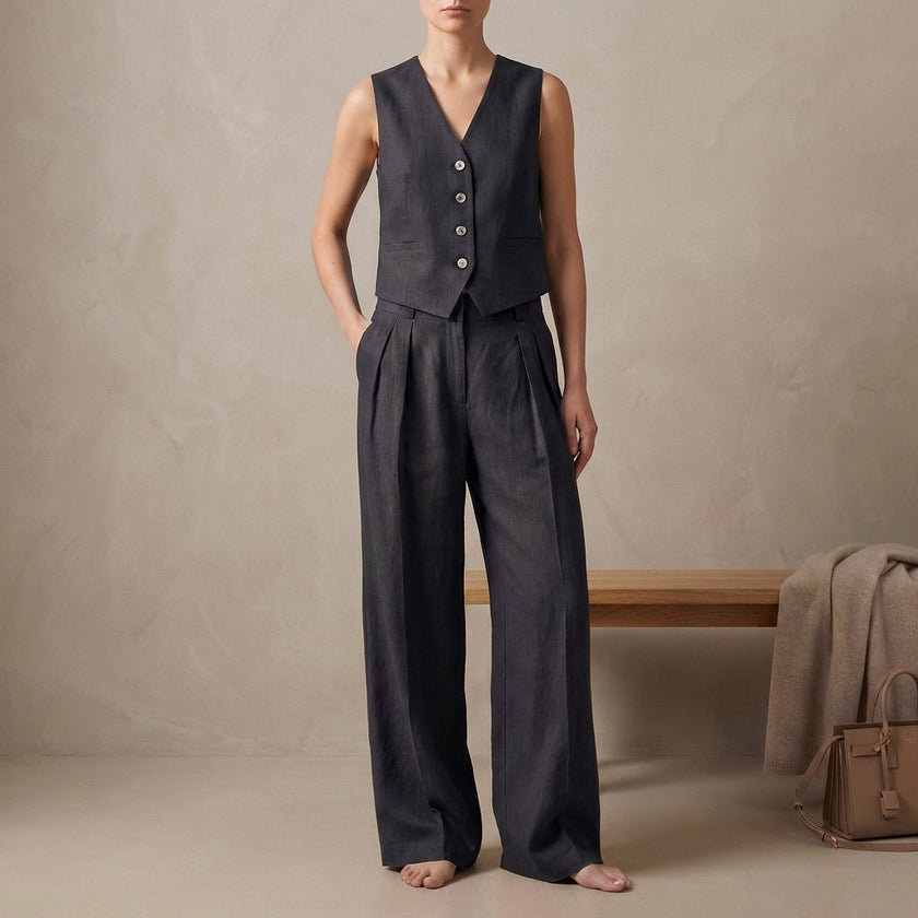 FJØRNA black tailored linen sleeveless vest with high-waisted pleated trousers, stylish 2-piece linen set on a model.