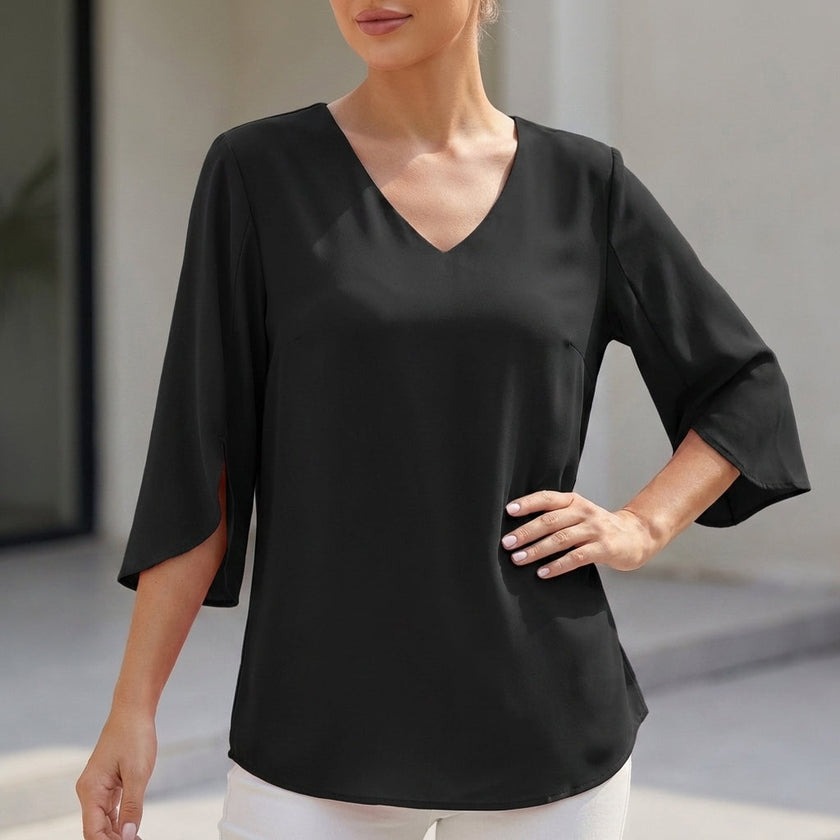 Black FJØRNA women's V-neck blouse with curved hem and slit sleeves, flowing design perfect for casual or dressy occasions.