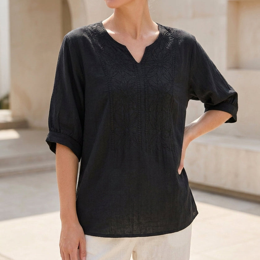 Black floral linen summer blouse for women with V-neck, flowy fit by FJØRNA, perfect for warm weather and casual occasions.