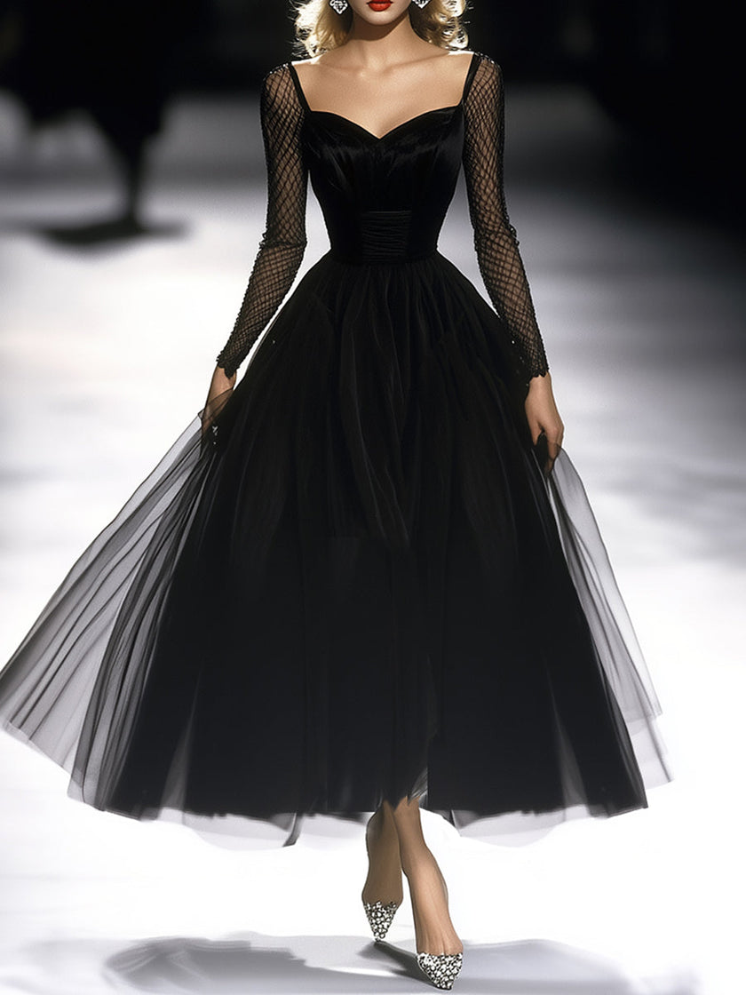 FJØRNA black maxi dress for women, flowing long dress with sleeveless design and elegant neckline, styled for a sophisticated look.