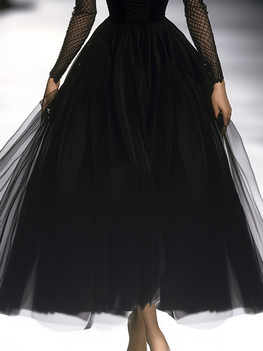 Black FJØRNA maxi dress for women, flowing long dress with sleeveless design and elegant V-neck, displayed on a hanger.