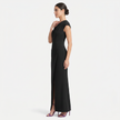 Black women's one-shoulder maxi evening dress with asymmetric neckline, shown from a side profile by FJØRNA.