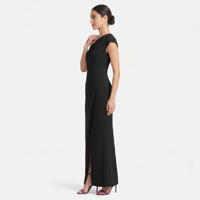 Black women's one-shoulder maxi evening dress with asymmetric neckline, shown from a side profile by FJØRNA.