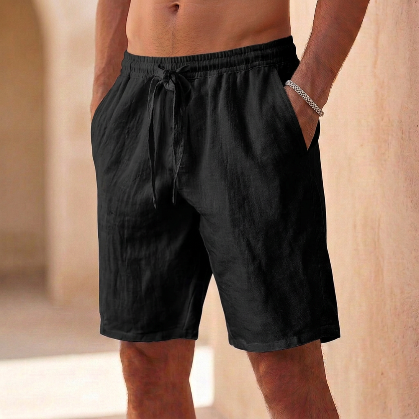 Black men's casual drawstring shorts with straight legs and pockets, made by FJØRNA.