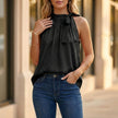 FJØRNA women's summer blouse in black with leopard print, halter neck style, lightweight and stylish top for warm weather.