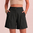 Black FJØRNA summer women's linen shorts with high waist and pockets, breathable fabric, shown on a model.