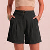 Black FJØRNA summer women's linen shorts with high waist and pockets, breathable fabric, shown on a model.