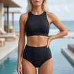 Black FJØRNA summer bikini for women with high neck and high waist, showcasing a stylish swimwear design.