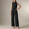 Black FJØRNA women's two-piece set with high waist and high neck, featuring a stylish coordinated top and matching skirt.