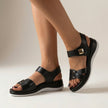 Black FJØRNA orthopedic platform strap sandals with buckle detail, showcasing comfortable footbed and stylish design.