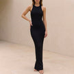 Black ribbed bodycon high neck sleeveless maxi dress for women by FJØRNA, shown on a model highlighting its sleek fit and elegant design.