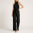 Black FJØRNA Celeste pleated halter top and wide-leg pant 2-piece set, featuring stylish pleats and relaxed fit.