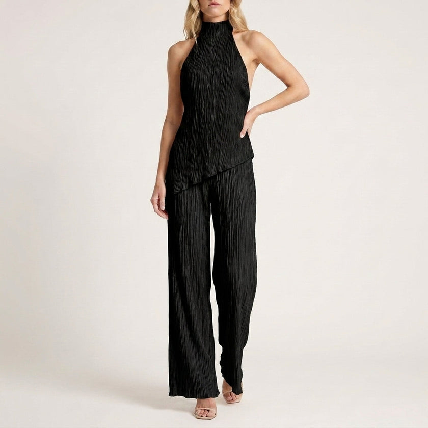 Black FJØRNA Celeste pleated halter top and wide-leg pant 2-piece set, featuring stylish pleats and relaxed fit.