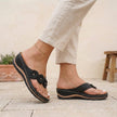 Black FJØRNA orthopedic floral applique wedge thong sandals for women with decorative flower details on the straps.
