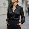 Black FJØRNA summer women's blouse with striped pattern and high waist, shown on a model.