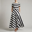 Black FJØRNA A-line striped maxi dress with pockets, featuring a flowy design and casual elegance for women.