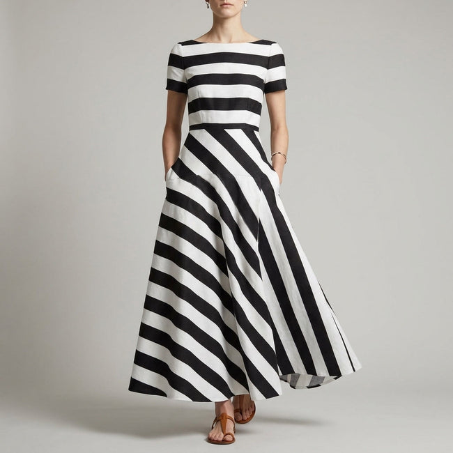 Black FJØRNA A-line striped maxi dress with pockets, featuring a flowy design and casual elegance for women.