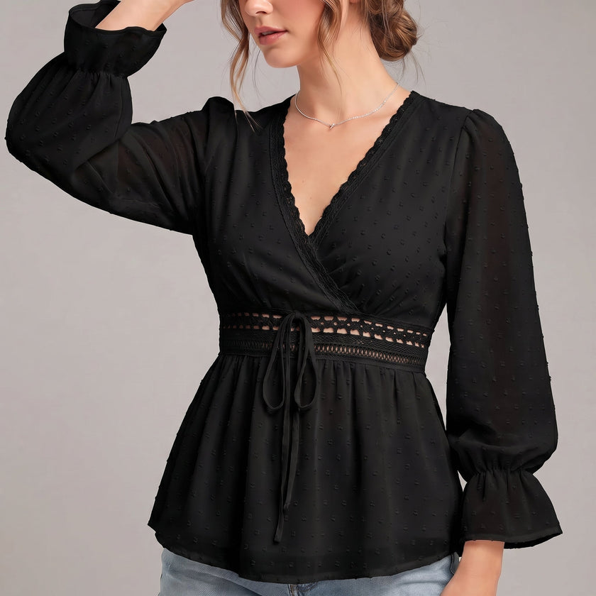 Black women's summer blouse by FJØRNA with a V-neck, linen fabric, and ruffle details, styled as a casual top.