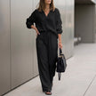 Black FJØRNA oversized two-piece crinkle-texture suit with relaxed fit and drawstring waist, stylish and comfortable for casual wear.