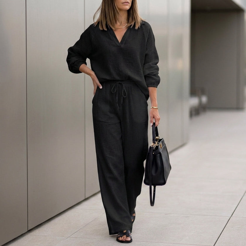 Black FJØRNA oversized two-piece crinkle-texture suit with relaxed fit and drawstring waist, stylish and comfortable for casual wear.