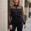 Black FJØRNA summer women's blouse with mesh fabric and button front, stylish top for warm weather.