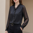 Black women's summer blouse by FJØRNA with V-neck and puff sleeves, made from lightweight chiffon fabric.