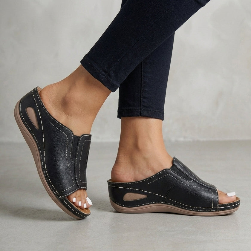 Black FJØRNA orthopedic wedge open-toe slide sandals for women, featuring supportive design and open toe for comfort.