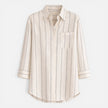 Women's striped button-down shirt by FJØRNA, relaxed fit, lightweight blouse with blue and white stripes.