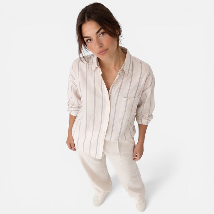 Women's striped button-down shirt by FJØRNA, lightweight and relaxed fit, featuring classic vertical stripes and a casual style.