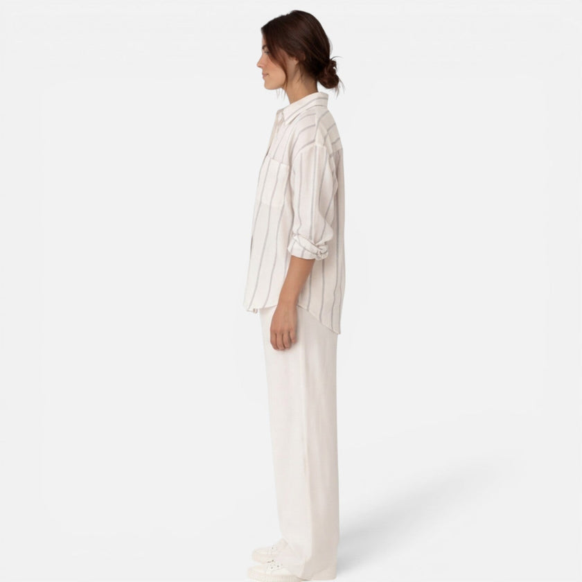 Women's striped button-down shirt by FJØRNA, relaxed fit and lightweight, shown on a model with long sleeves and classic collar.