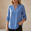 Blue V-neck linen summer blouse for women, flowy and lightweight, by FJØRNA, perfect for warm weather and casual style.