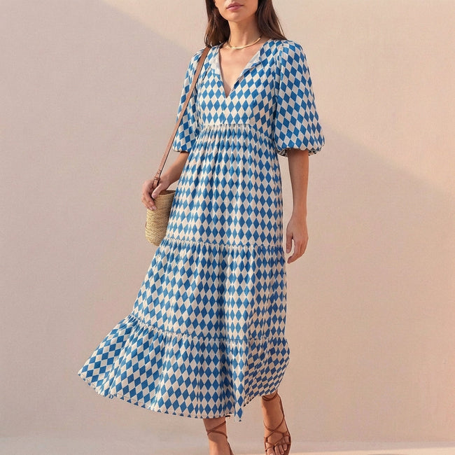 Blue FJØRNA women's elegant maxi dress with V-neck and puff sleeves, flowing fabric perfect for formal or casual occasions.