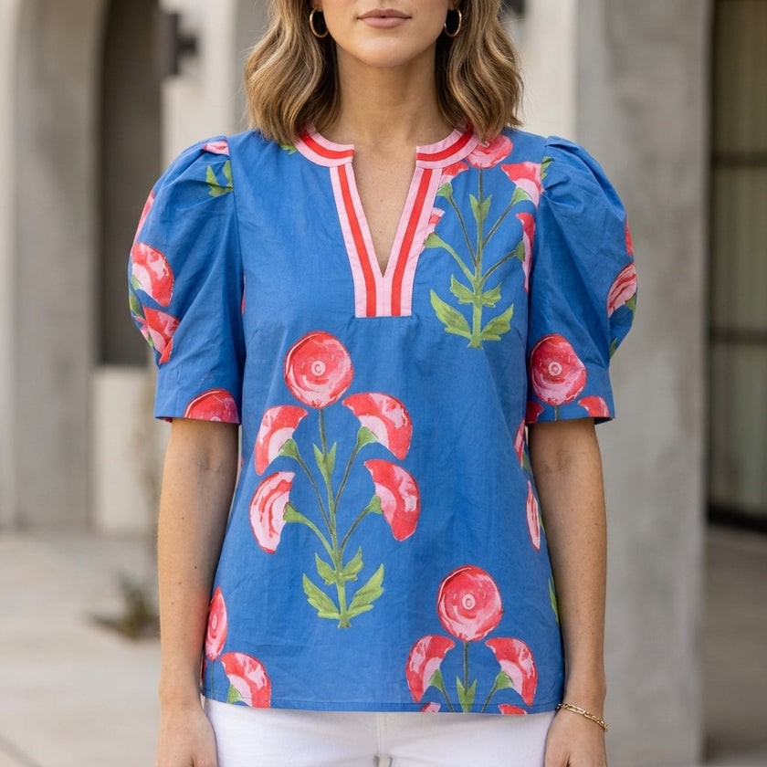 Blue floral summer blouse for women by FJØRNA featuring a V-neck, puff sleeves, and high waist, perfect for warm weather.