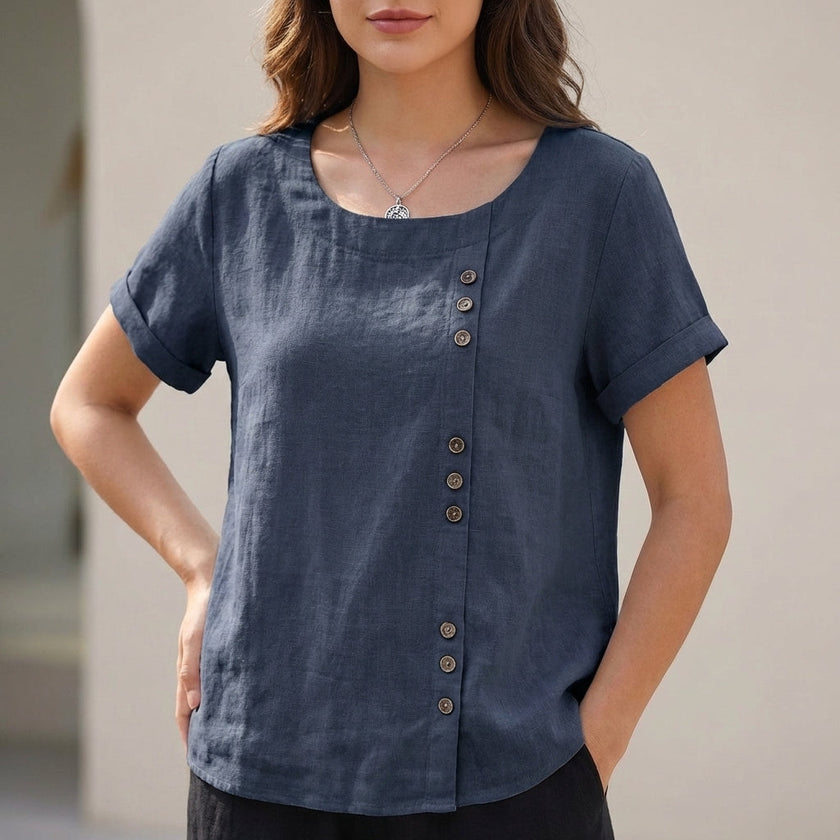 Blue women's linen blouse by FJØRNA with relaxed fit and asymmetric detail, ideal for casual daywear.