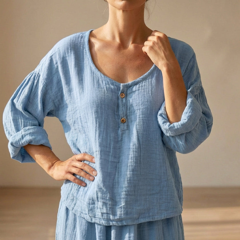 Blue FJØRNA summer women's blouse with a V-neck, linen fabric, flowy and breathable for warm weather.