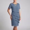 Blue FJØRNA flowing tiered mini dress with ruffled sheer sleeves, showcasing a lightweight, elegant design.