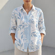 Blue FJØRNA women's tunic shirt with V-neck, collared design and roll-tab sleeves, styled as a casual women's top.