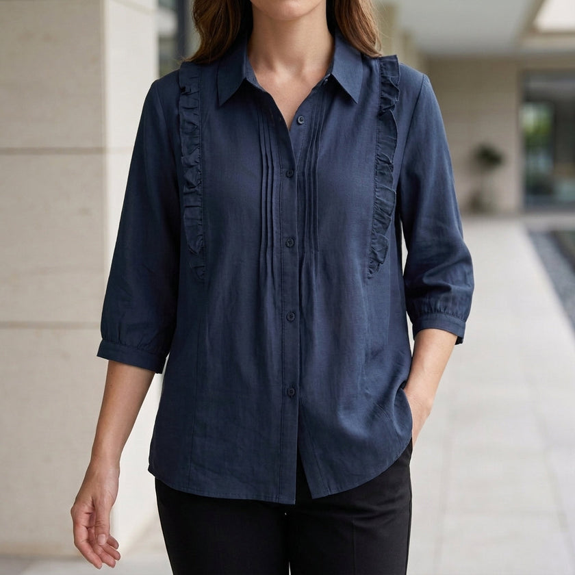 Blue denim ruffle summer blouse for women from FJØRNA, featuring a stylish, lightweight top with feminine ruffle details.