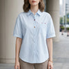 Blue denim summer blouse for women with puff sleeves and button front, casual FJØRNA top perfect for warm weather.