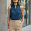 Blue sleeveless denim summer blouse for women by FJØRNA, featuring a casual sleeveless top style.